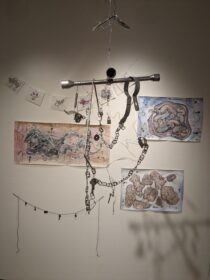 art exhibit with hanging metal piece