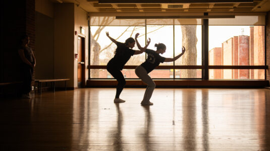 dancers in front of window