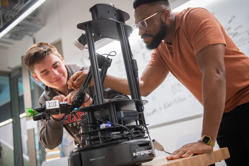 two students work in robotics lab