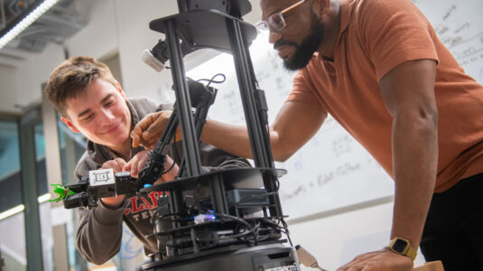 two students work in robotics lab