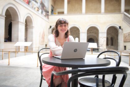 student with laptop in museum