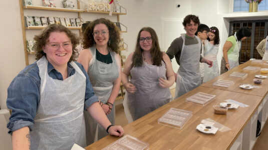 Students prepare to make chocolates in molds