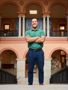 man posing for photo inside old building