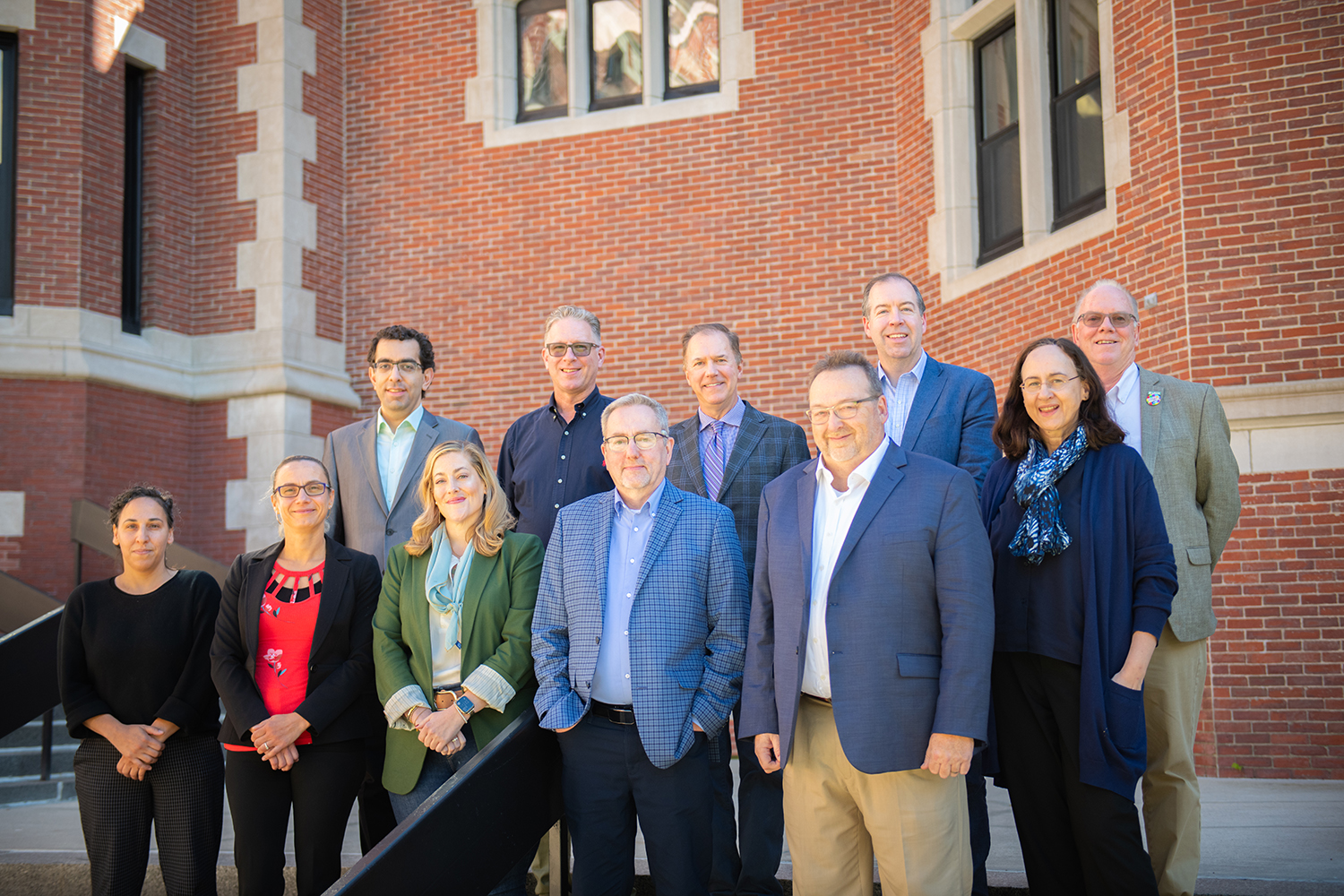 The visiting ESRI team joins Clark Center for Geospatial Analytics Director Hamed Alemohammad, President David Fithian and Provost John Magee on the steps of the Jefferson Academic Center.