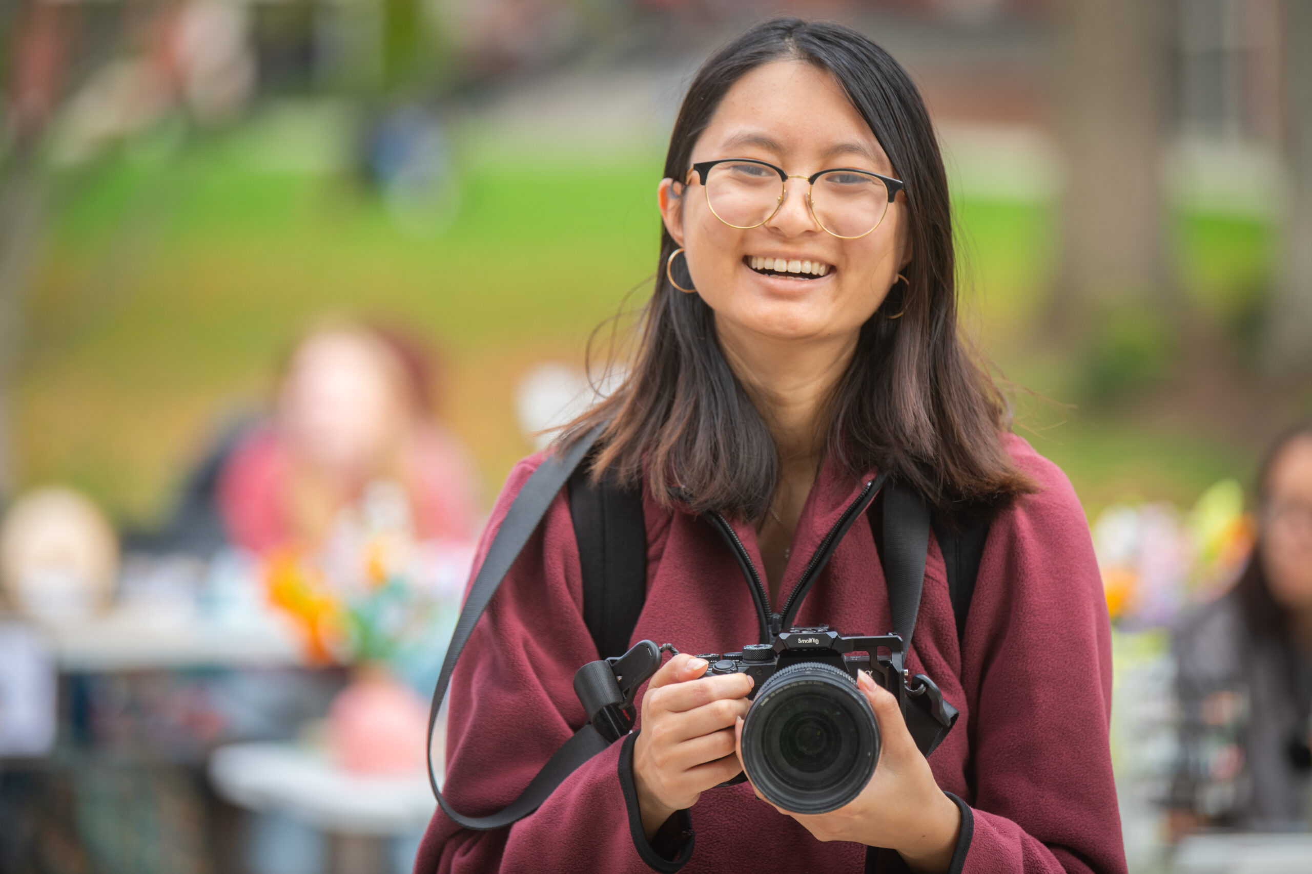 student poses with camera