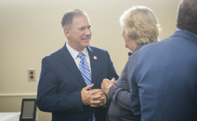 President Fithian talks to an attendee at the ribbon cutting