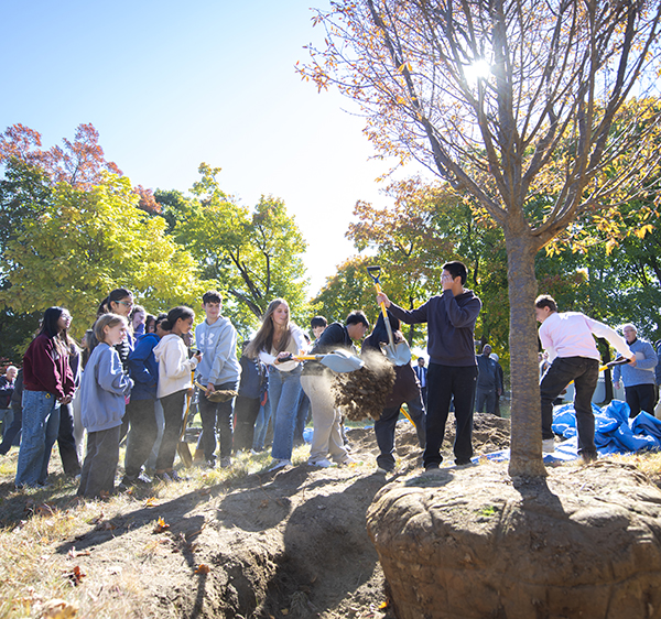 Goddard Scholar Academy students help plant a new cherry tree in honor of Robert Goddard's "Anniversary Day."