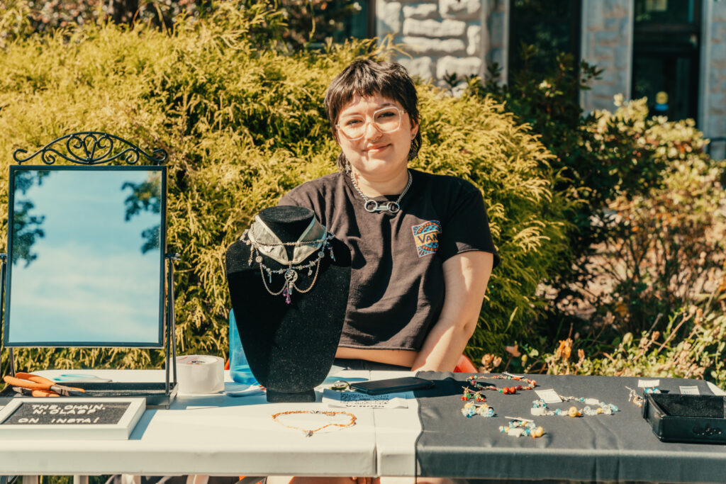 student poses with jewelry