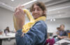 student holds yellow snake