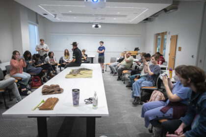 reptiles visit classroom with long table and seated students