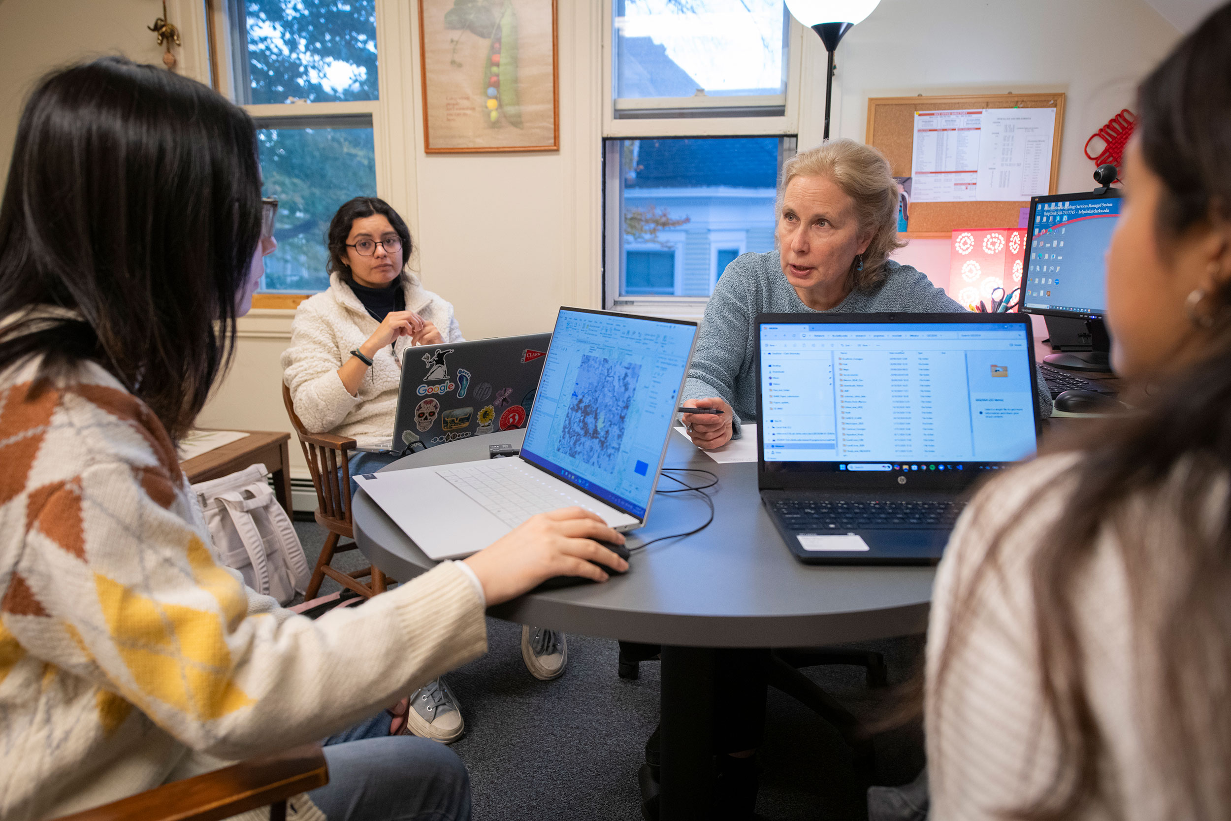 Yelena Ogneva-Himmelberger working with graduate students in her office.