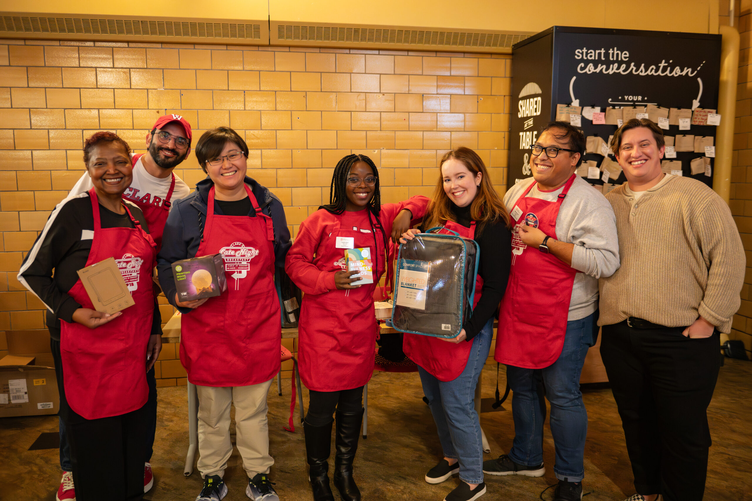 faculty serve students in the dining hall during late-night breakfast