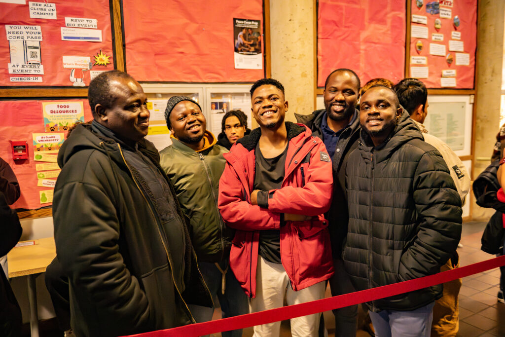 faculty serve students in the dining hall during late-night breakfast