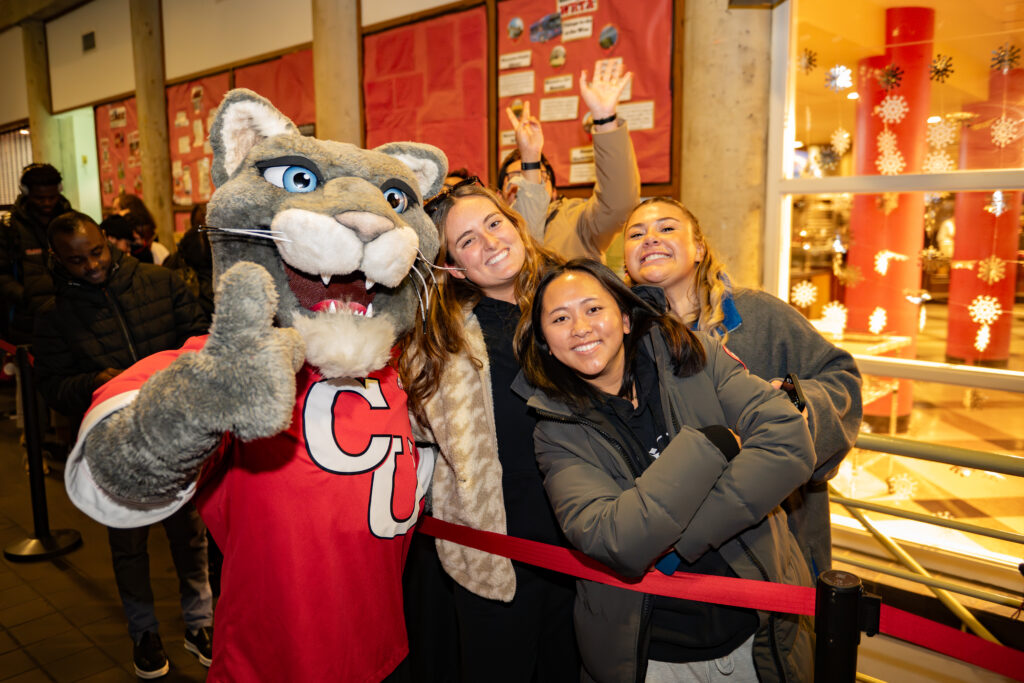 faculty serve students in the dining hall during late-night breakfast