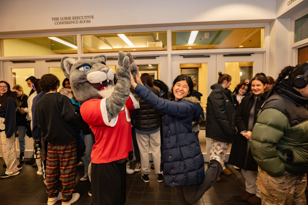 faculty serve students in the dining hall during late-night breakfast