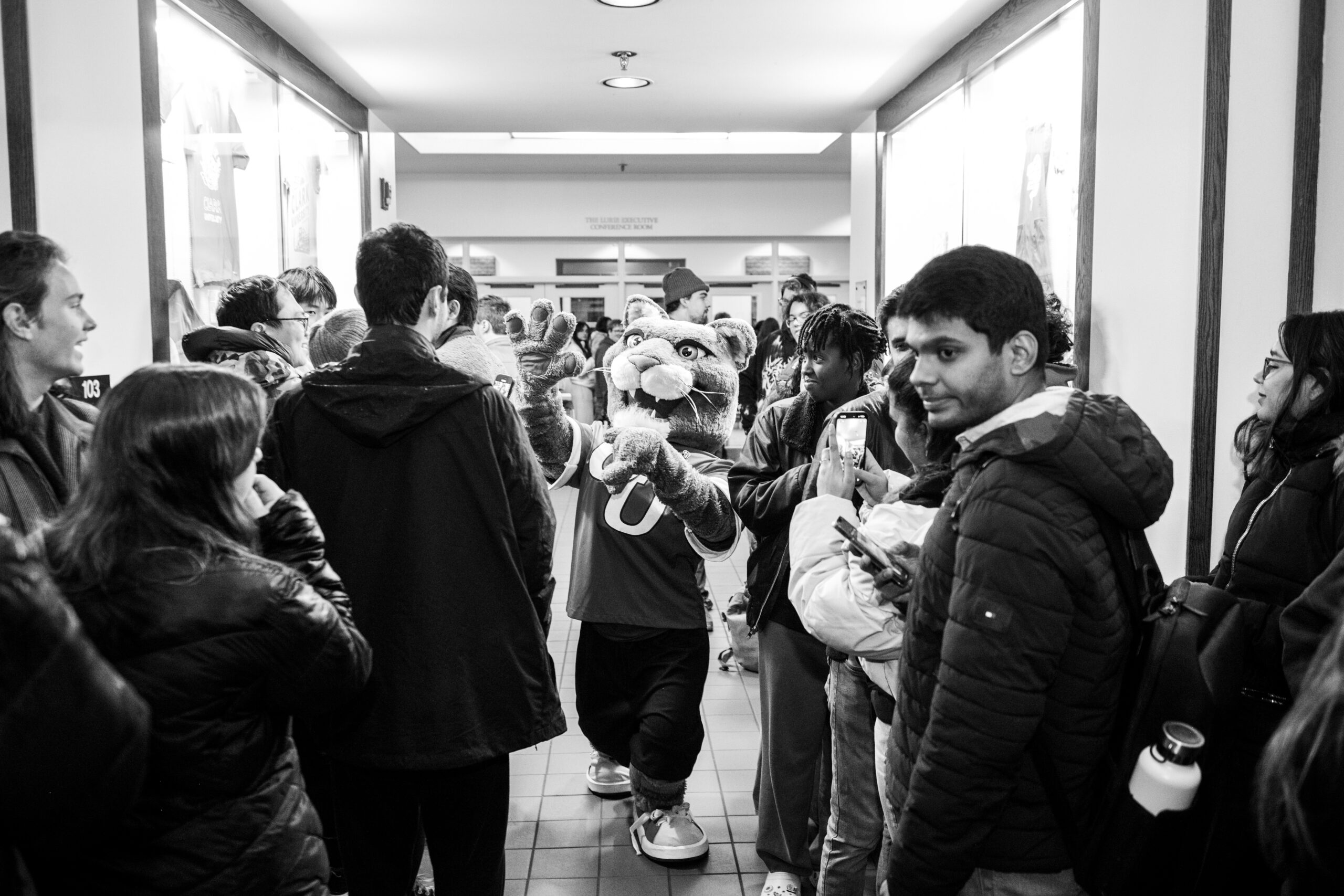 faculty serve students in the dining hall during late-night breakfast