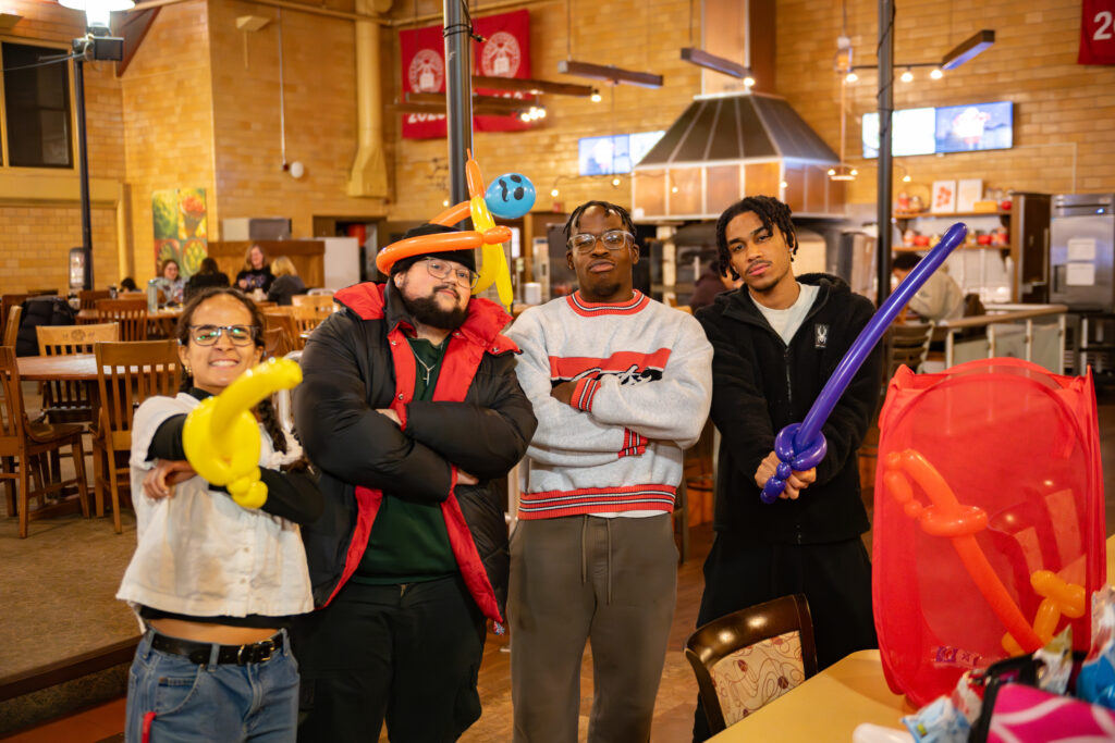 faculty serve students in the dining hall during late-night breakfast