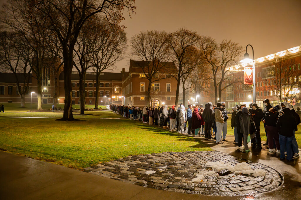 faculty serve students in the dining hall during late-night breakfast