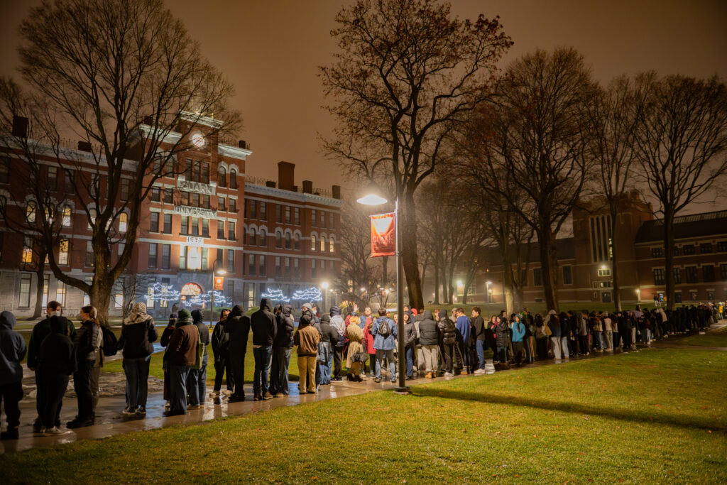 faculty serve students in the dining hall during late-night breakfast