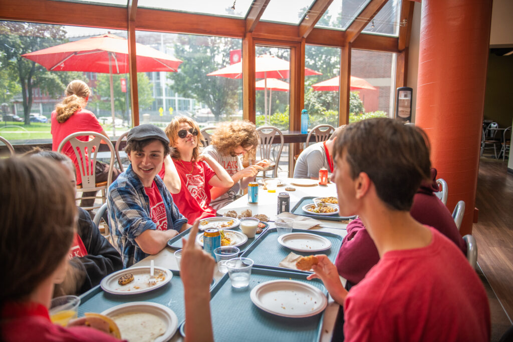 students eat lunch around table