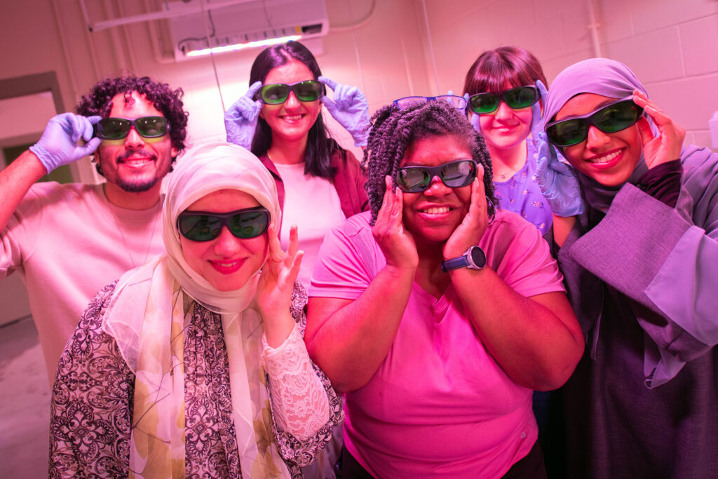 Biologist Chandra Jack surrounded by students who conduct research in her lab, including in the EPIC grow space