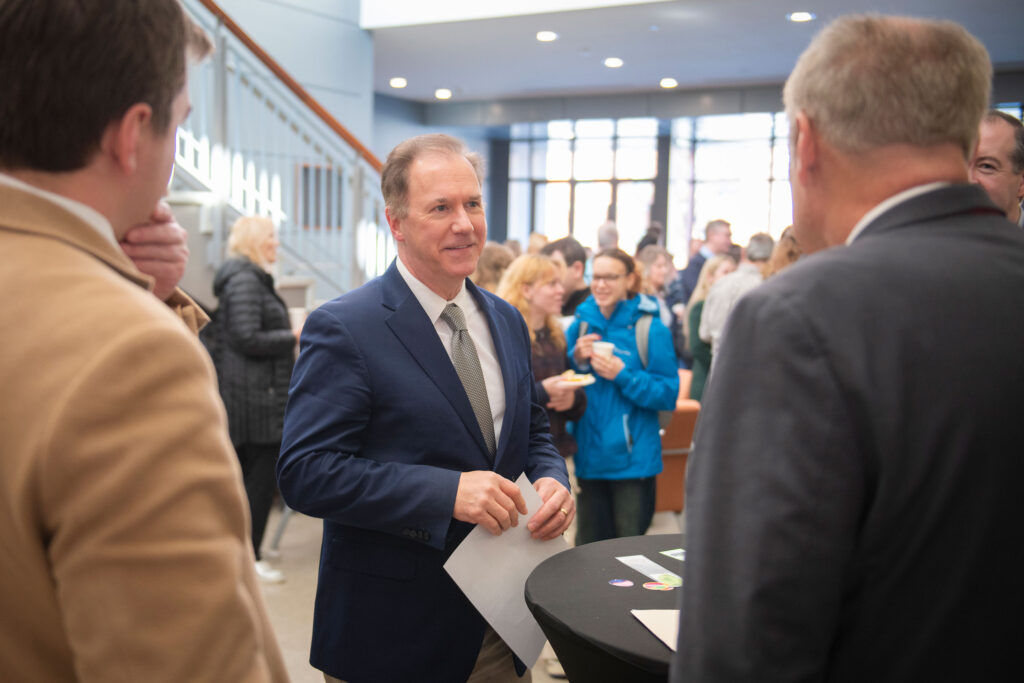 President David Fithian talks with Worcester Mayor Joseph Petty, right, and