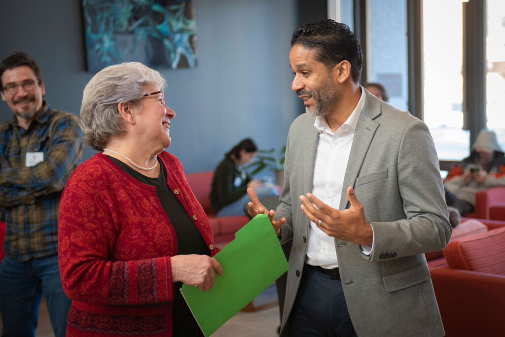 Biology Chair and Professor Deborah Robertson talks to Worcester City Councilor Luis Ojeda.