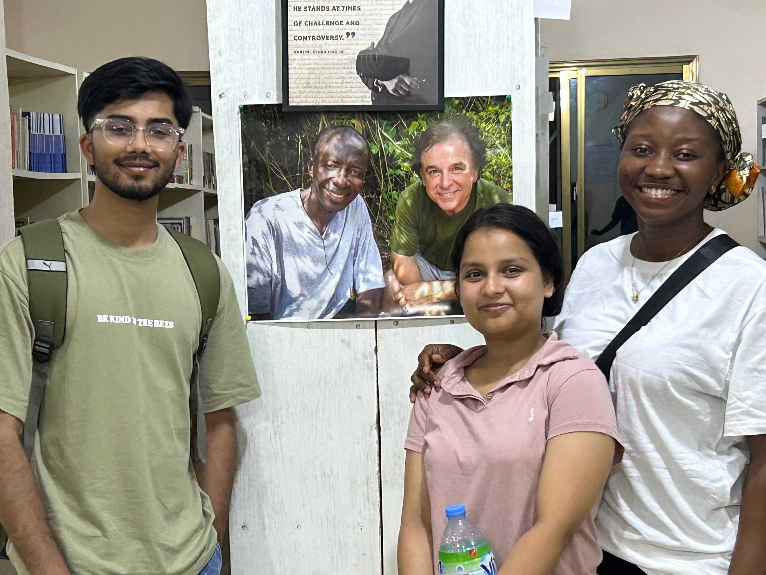 people pose for photo in library