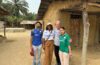 four people pose for photo outside