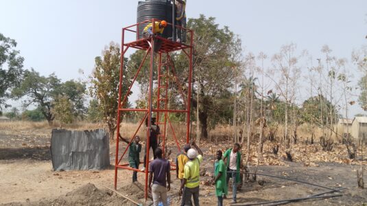 people work on water pump in africa