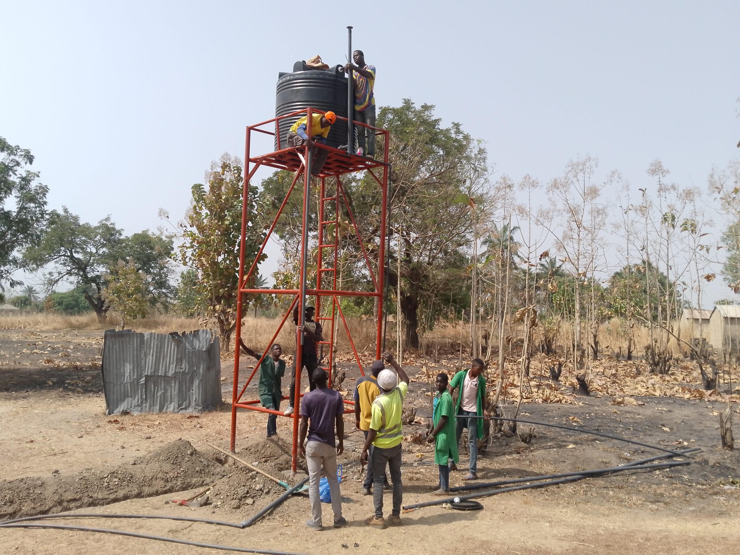 people work on water pump in africa