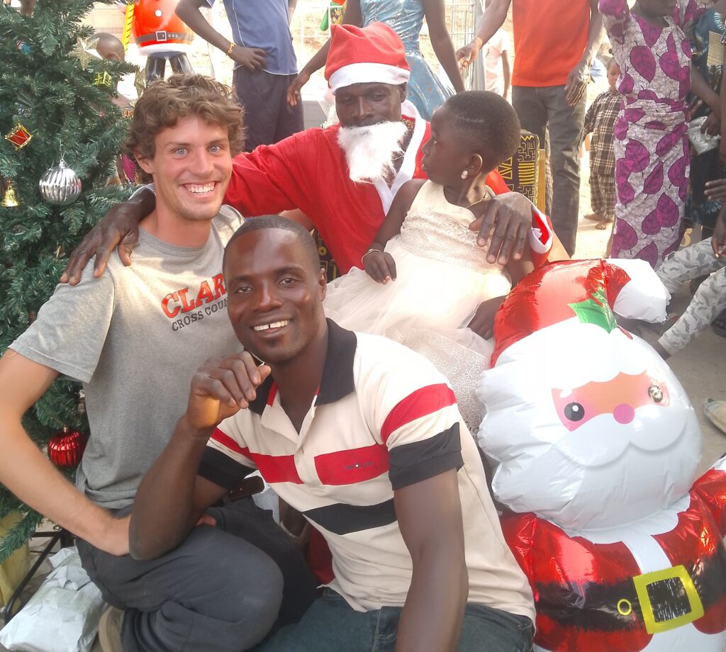 people pose for photo with christmas tree