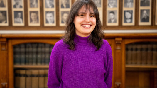 headshot of student wearing purple sweater