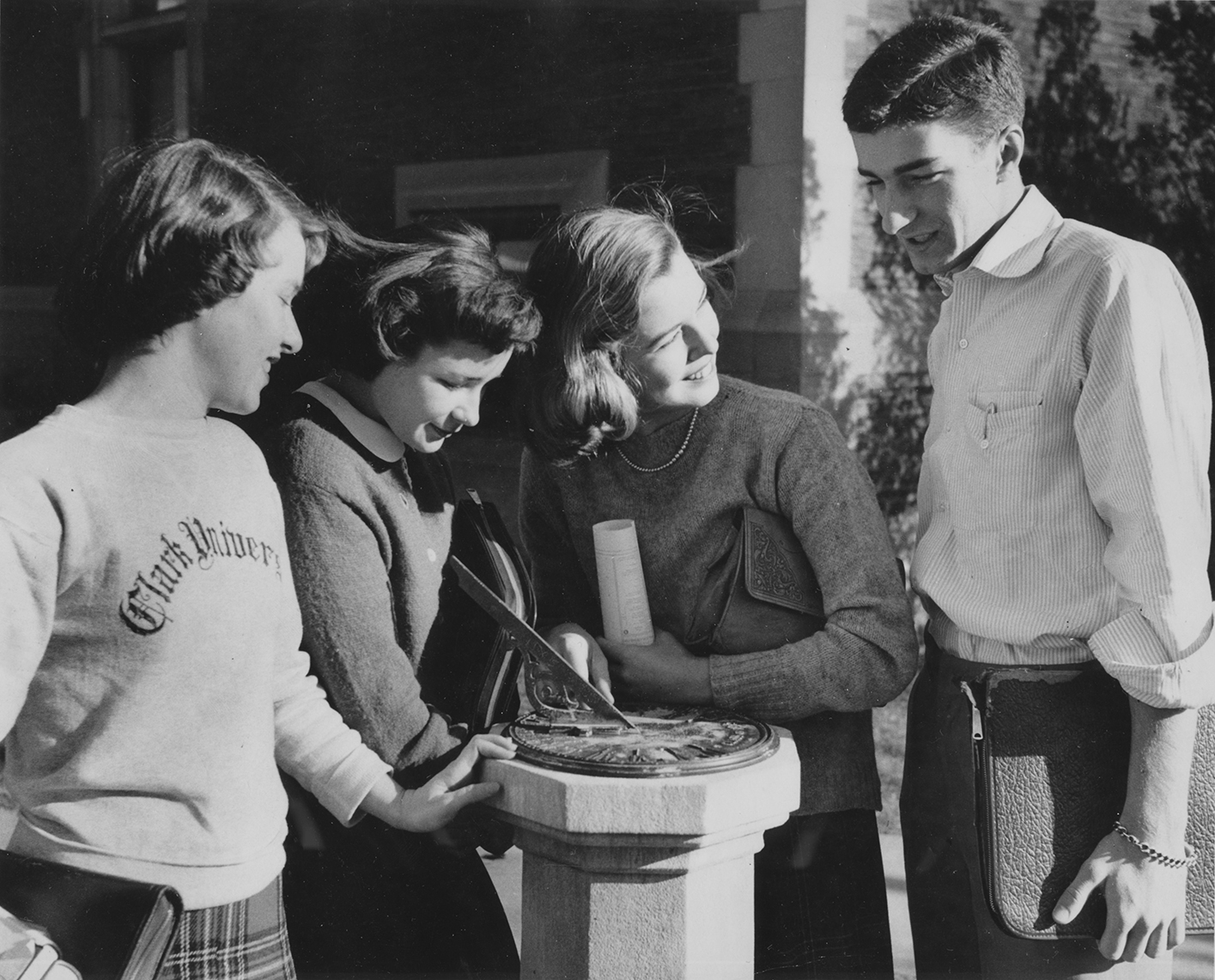 Students stand around a sundial on the Clark University campus (undated)